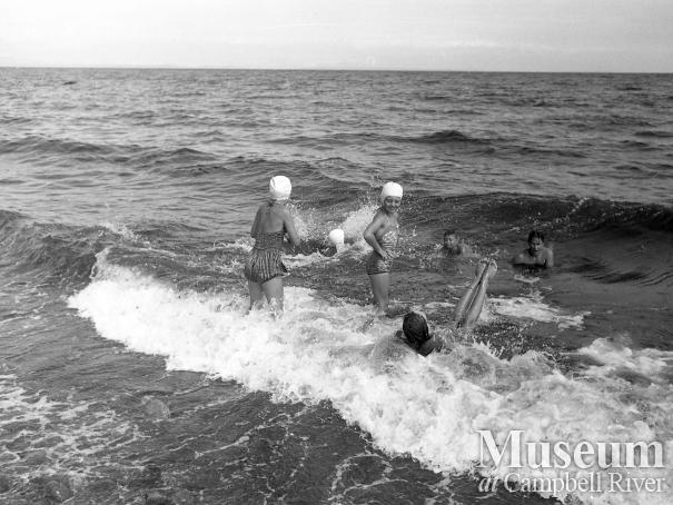 Group of people swimming, possibly at Storie's Beach