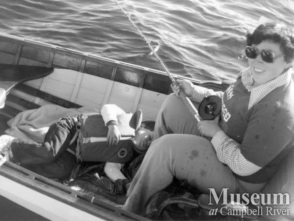 Lady with child asleep in boat