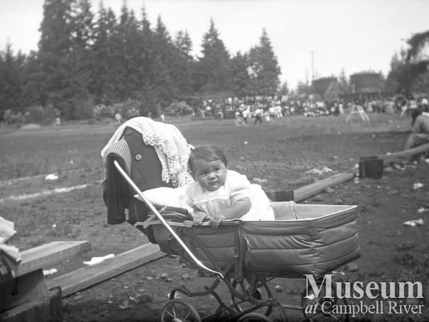 An unidentified child in the Henderson baby buggy