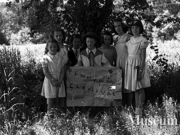 A group of children advertising a Penny Carnival