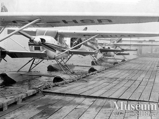 Seaplanes tied up at dock at Tyee Spit, 1976.